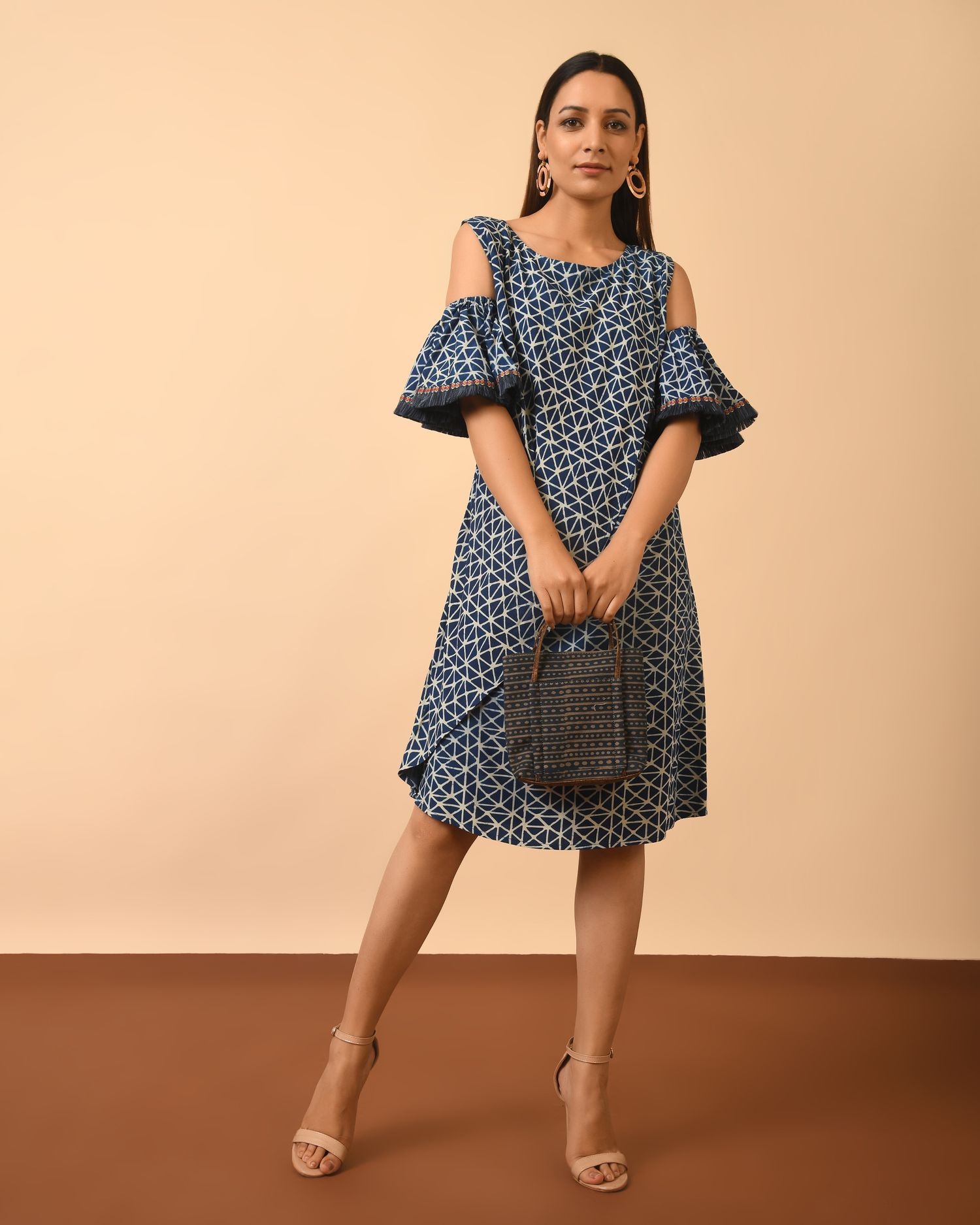 Model wearing Beautiful Indigo Dyed Dabu Print cold shoulder Dress holding bag